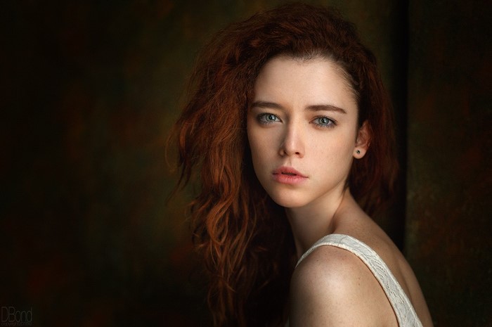 Portrait of a young woman with red wavy hair