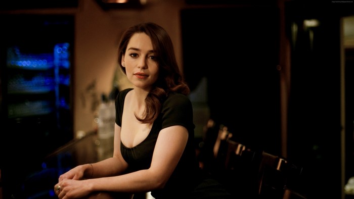 Emilia Clarke posing at a bar