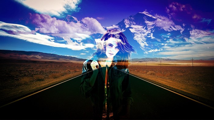 Woman superimposed on a desert road with mountains and clouds