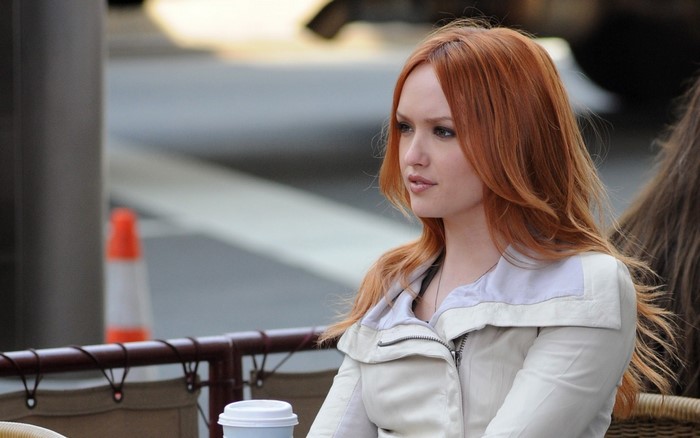 Woman with red hair wearing a jacket
