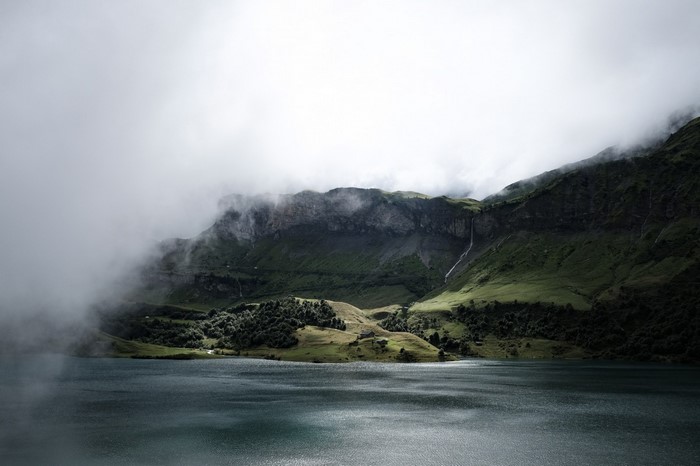 Misty mountains over a lake