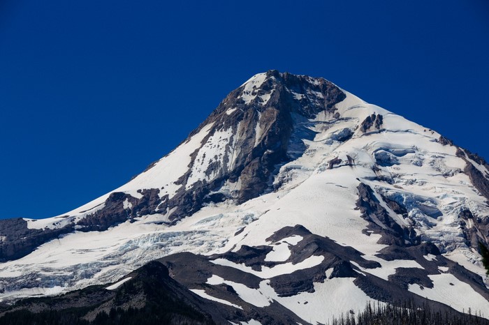 Snow-covered mountain peak under a clear blue sky