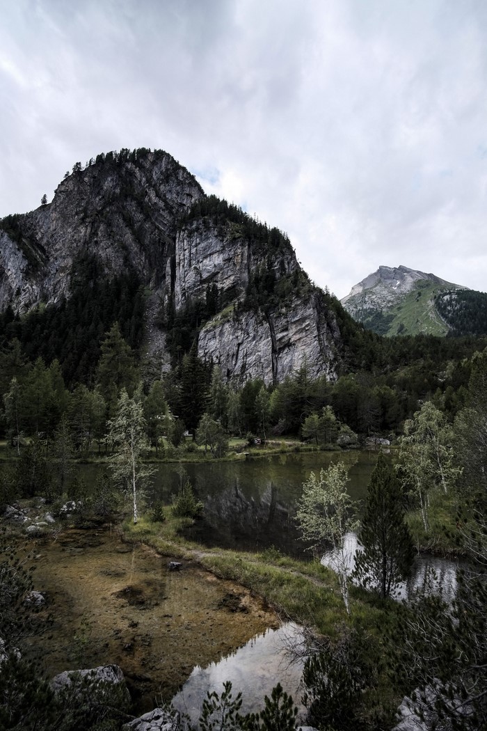 Mountain lake with rocky peaks and evergreen forest
