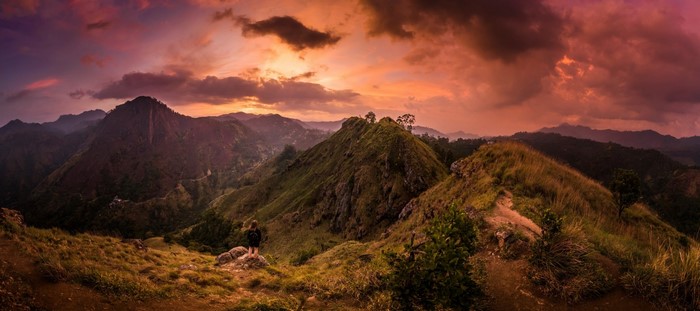 Person on a mountain ridge at sunset