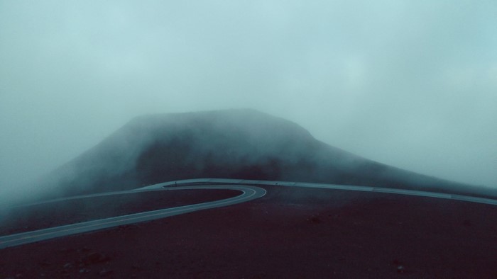 Winding road through a foggy mountain landscape