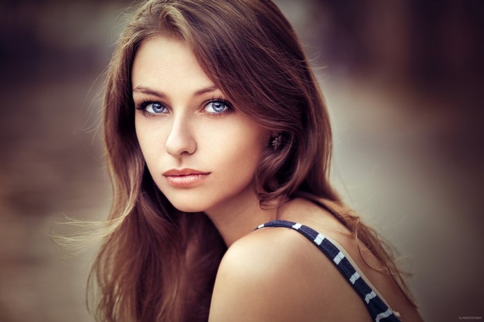 Portrait of a young woman with blue eyes and brown hair