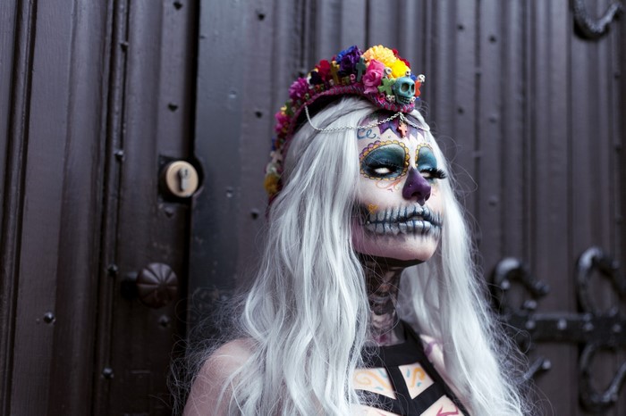 Woman in Dia de los Muertos makeup and flower crown