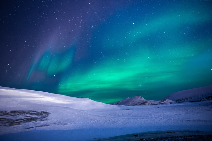 Aurora Borealis over snowy mountains