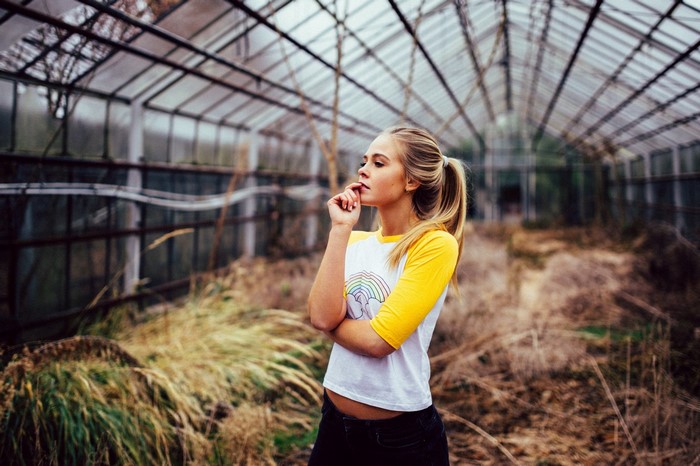 Woman in a greenhouse with a rainbow shirt