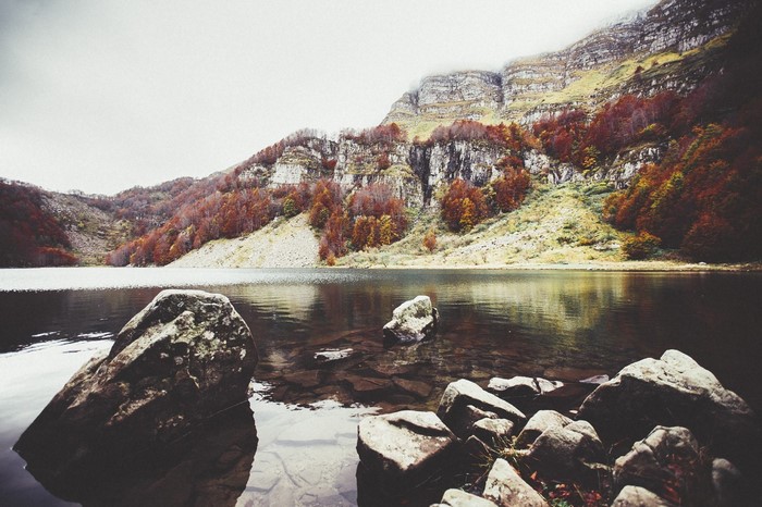 Autumn mountain lake with rocks and reflection
