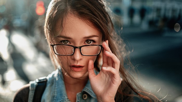 Woman wearing glasses looking at viewer