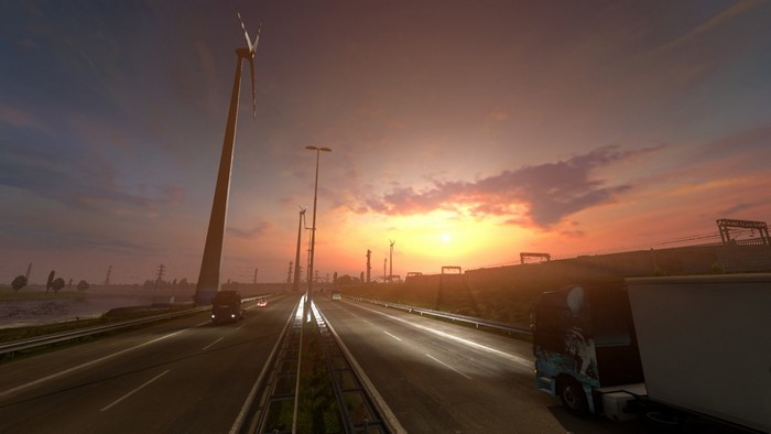 Sunset over highway with trucks and wind turbines in Euro Truck Simulator 2