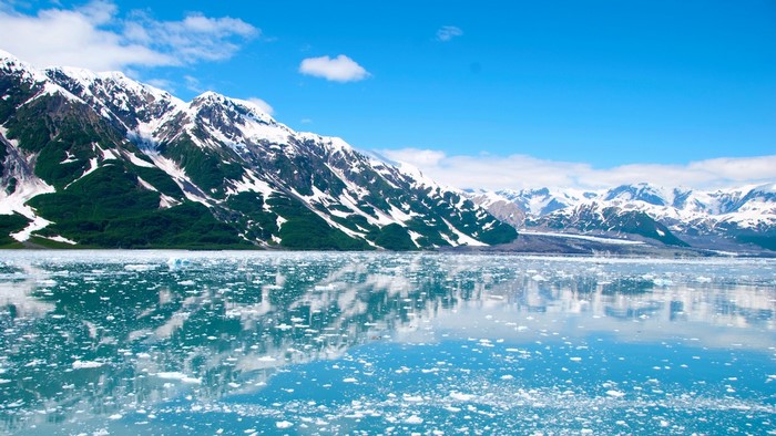Snow-capped mountains and glaciers reflected in icy water