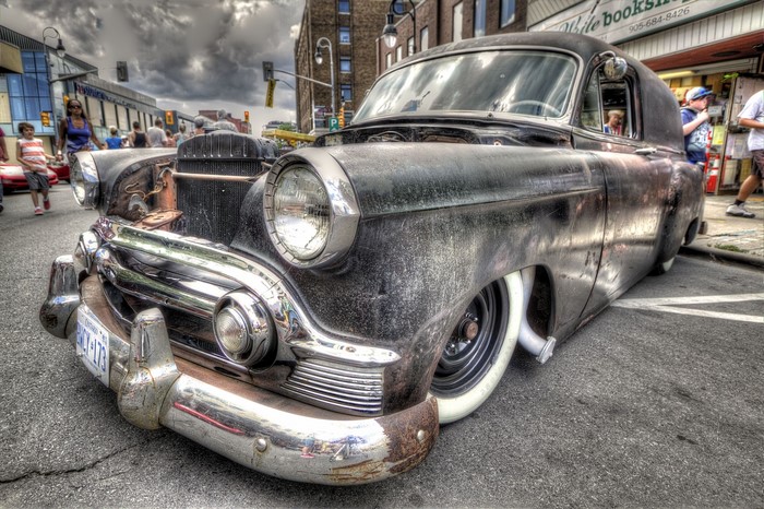 Customized vintage black sedan with whitewall tires