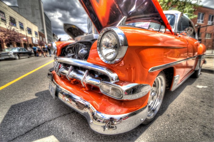 Orange vintage car with hood open