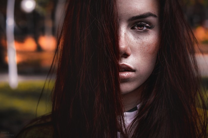 Woman with long brown hair and freckles