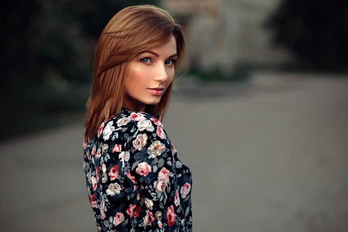 Woman with long brown hair wearing a floral dress