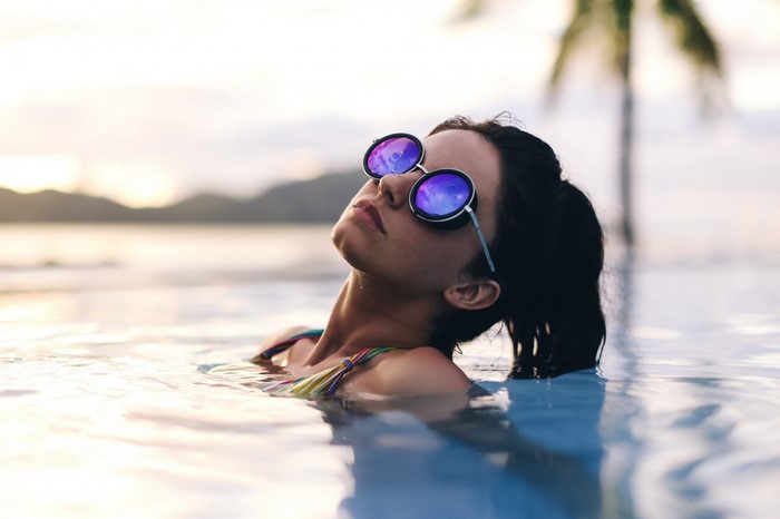 Woman in sunglasses in a swimming pool