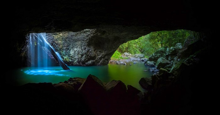 Cave with waterfall and turquoise pond in Australia