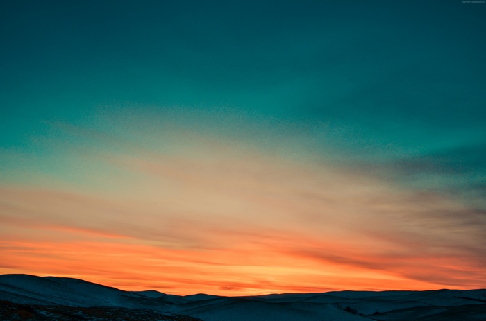 4K sunset over snow-covered mountains