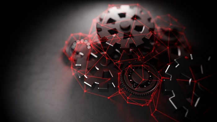 Gears connected by red network lines on dark surface