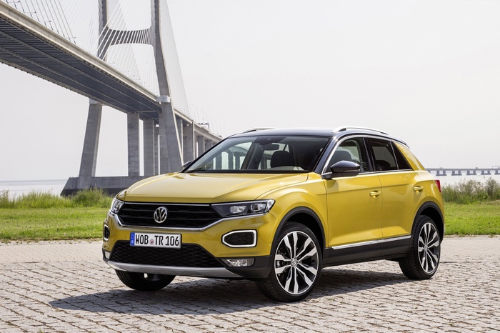 Yellow Volkswagen T-Roc parked near a bridge