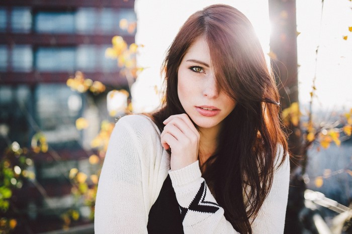 Woman with long brown hair and white cardigan