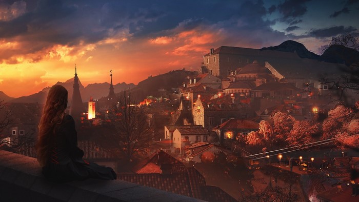 Woman watching a sunset over a European cityscape