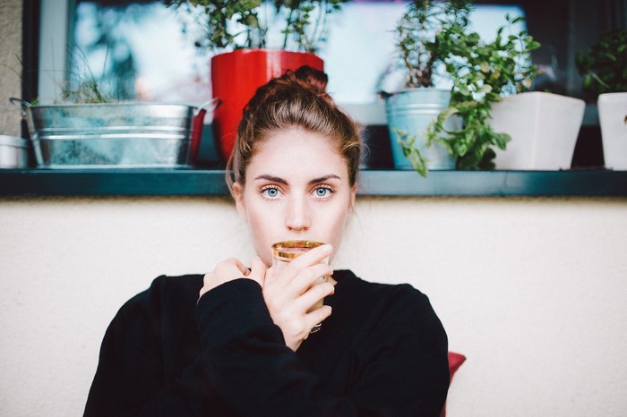 Woman with blue eyes drinking from a glass