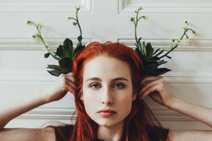Redhead woman with flowers on her head