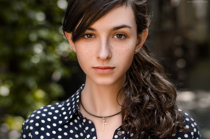 Portrait of a Young Woman with Freckles and Ponytail