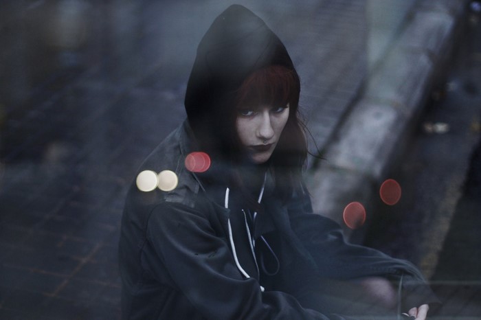 Woman with red hair wearing a hood