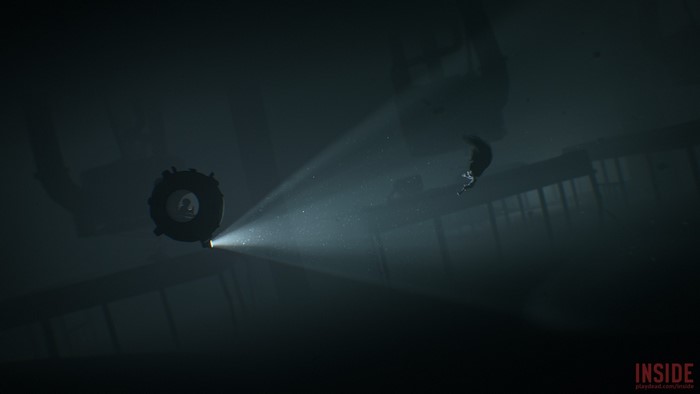 Boy in a submersible with a spotlight in a dark underwater environment