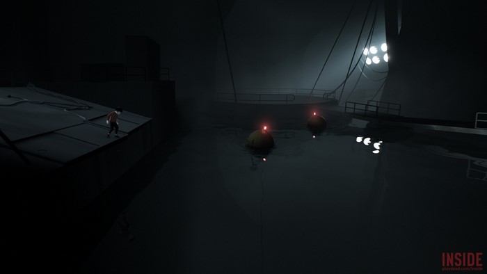 Boy on platform near water with buoys in Inside