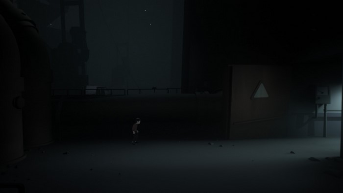 Boy in dark industrial area from Inside