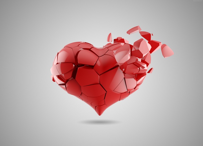 Red heart shattering into pieces