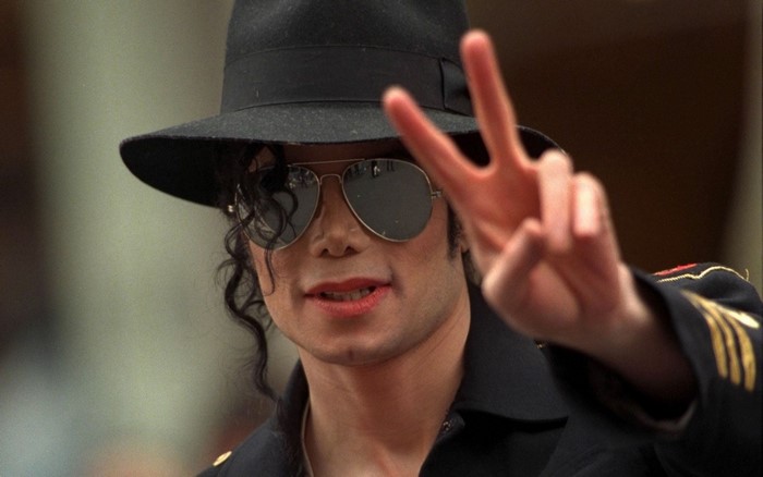 Michael Jackson wearing a hat and sunglasses