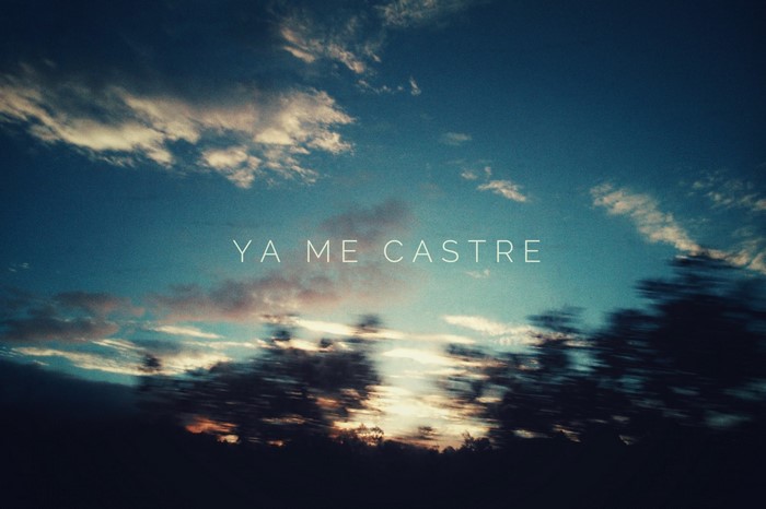 YA ME CASTRE text over sunset sky