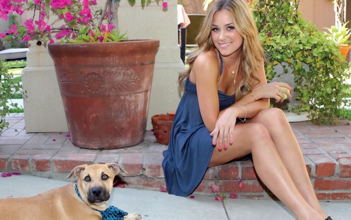 Woman and dog sitting outdoors