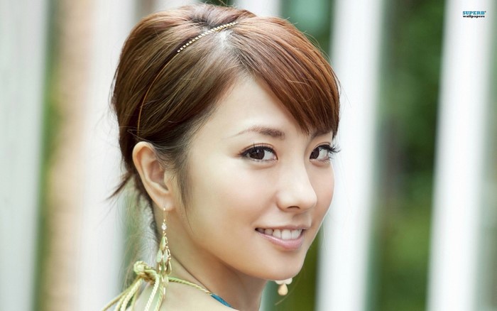 Asian woman with brown hair and earrings