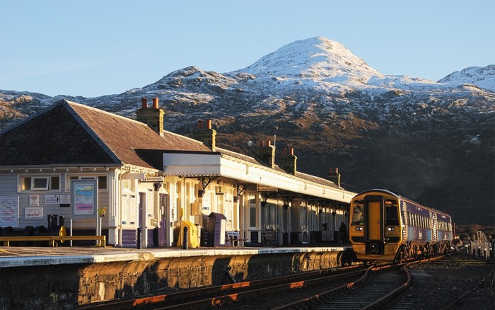 Train at a snowy mountain station in Scotland