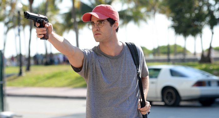 Andrew Cunanan from American Crime Story holding a gun