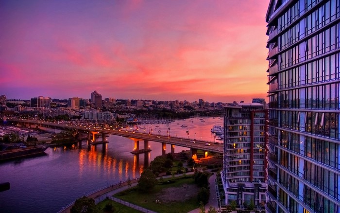Cityscape at sunset with bridge and modern buildings