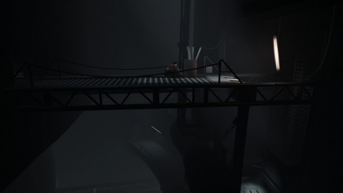 Man on a platform in a dark industrial setting