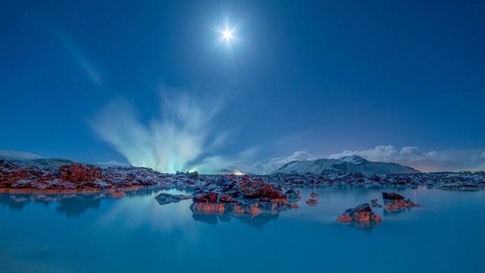 Aurora Borealis over a rocky lagoon in Iceland