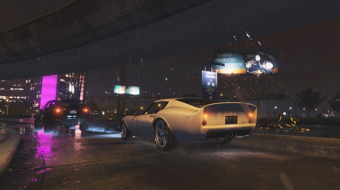 Cars driving on a wet road at night in Grand Theft Auto V