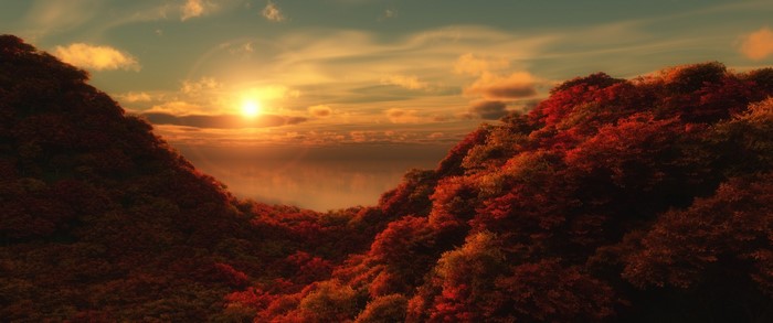 Autumn sunset over forested hills