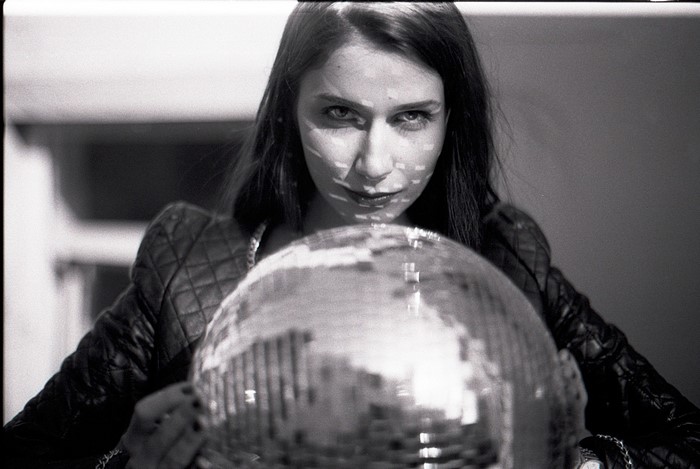 Woman with disco ball in black and white portrait
