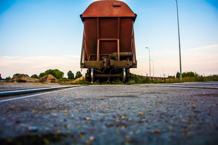 Rusty train car on railway tracks at dusk