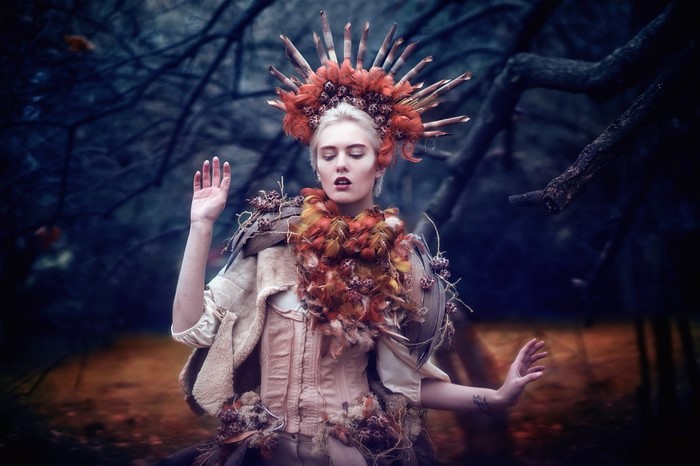 Woman in elaborate costume in forest